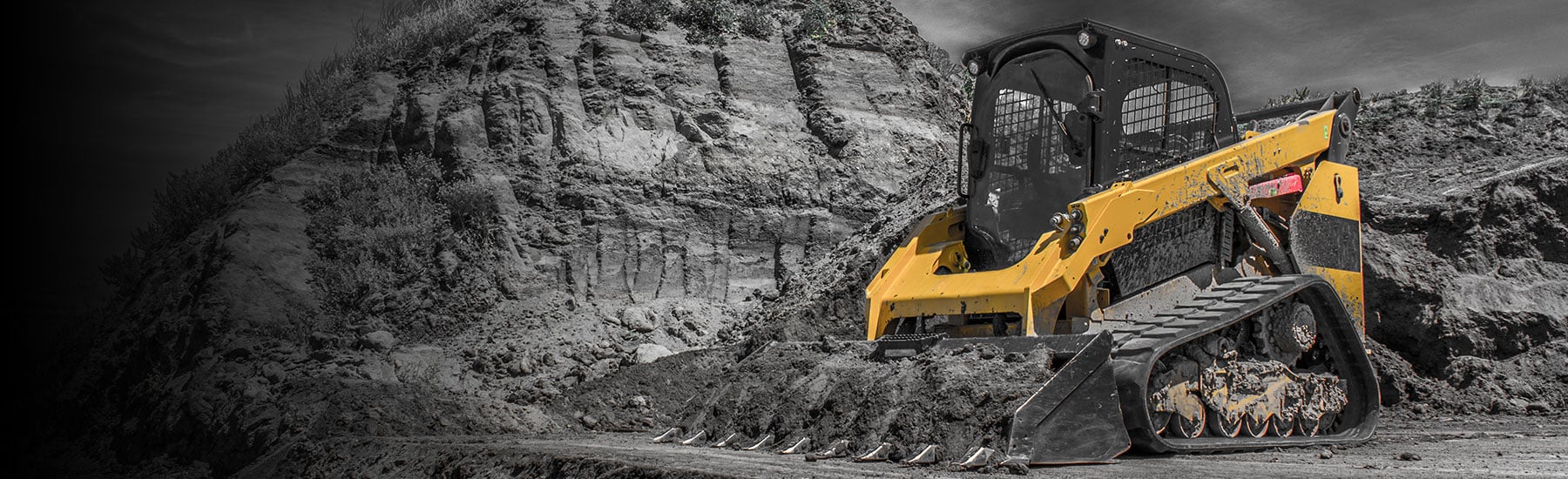 Skids steer working dirt on construction site
